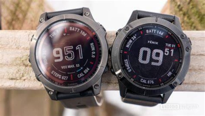 A Garmin Fenix 7 Sapphire Solar displays a clock face on a users wrist.