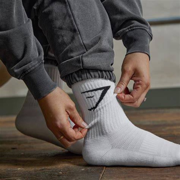 A model wearing crew socks and black Free People loafers