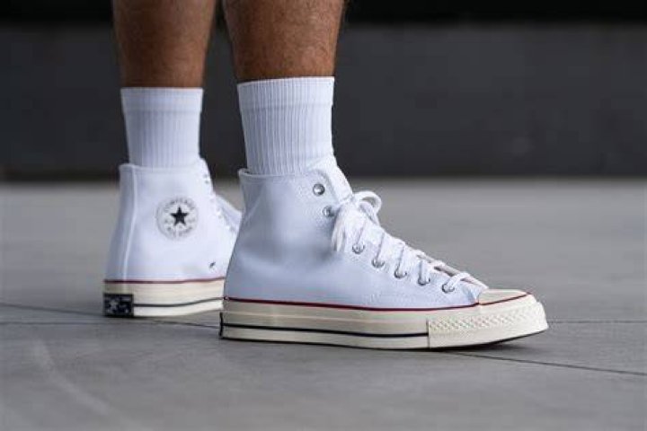 A white high top Converse sneaker