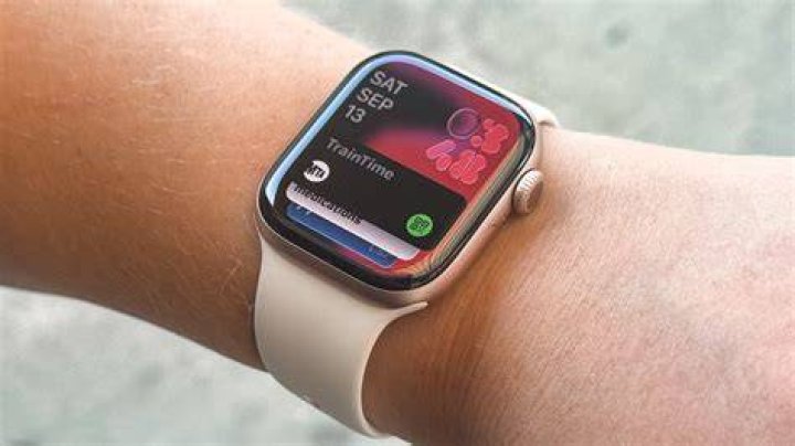 Apple Watch Series 7 Photo Face An Apple Watch Series 7 on a user's wrist displays an image of the Chrysler building in their Photo watch face.