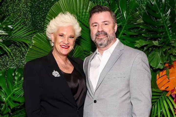 Anne Burrell and Stuart Claxton pose with family and friends at their wedding.