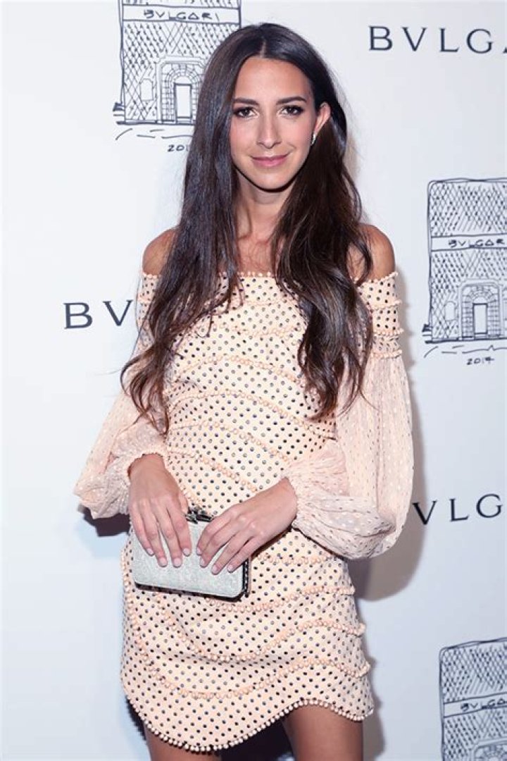 Arielle Charnas taking a selfie in a mirror without her wedding ring.