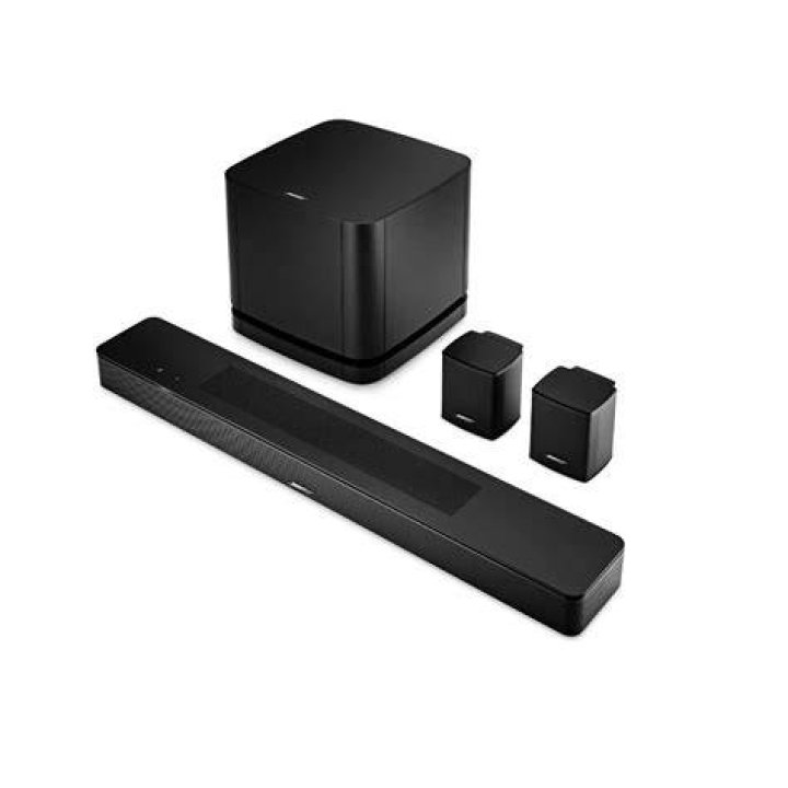 Bose_Soundbar_700 Bose smart speaker soundbars: Product image of the Bose Souundbar 700 (white) from Bose press release. The soundbar sits ona wood TV stand with a TV above it.
