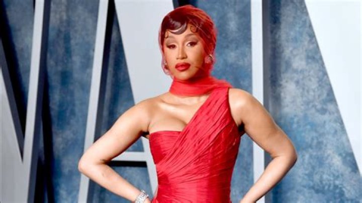 Cardi B wore a form-fitted black dress and stiletto heels with tights.