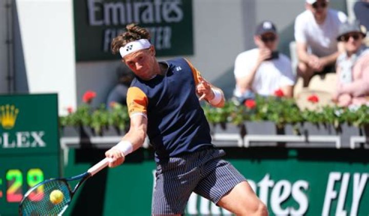 Casper Ruud forehands the ball at the French Open in 2023.