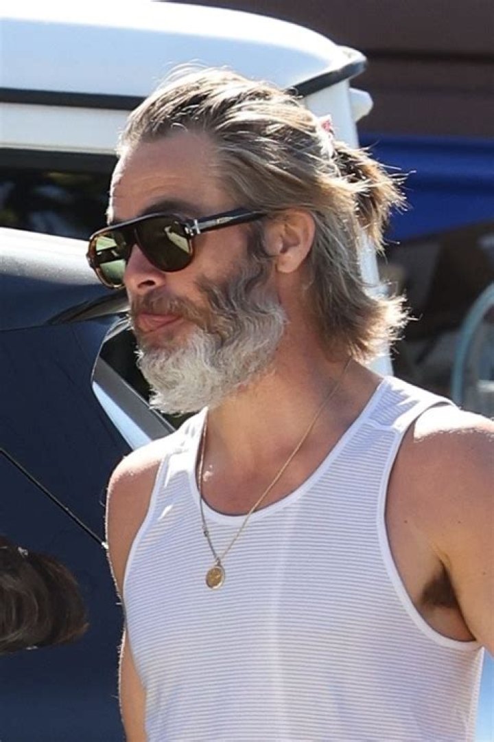 Chris Pine with hair pulled back in a half ponytail