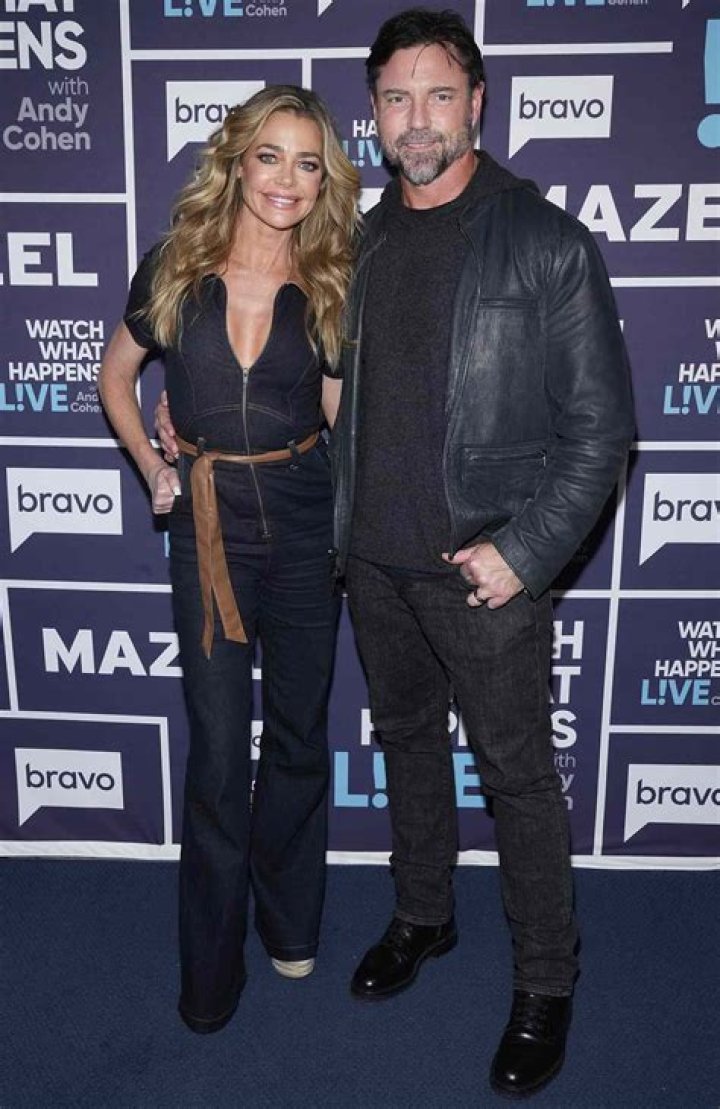 denise richards aaron phyper sitting at dinner table while filming real housewivse of beverly hills tv show