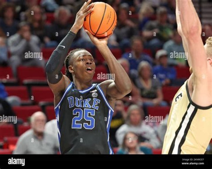Duke Blue Devils forward Mark Mitchell (25) shoots against North Carolina State Wolfpack forward Mohamed Diarra (23) and forward DJ Burns Jr. (30) in the second half in the finals of the South Regional of the 2024 NCAA Tournament at American Airline Center.