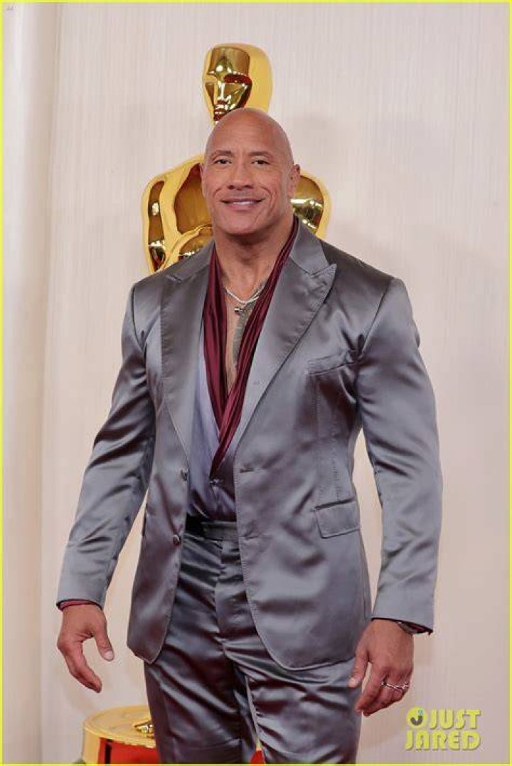 Dwayne Johnson smiling on a red carpet