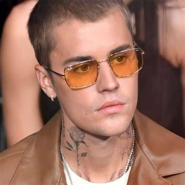 Justin Bieber lifting sunglasses