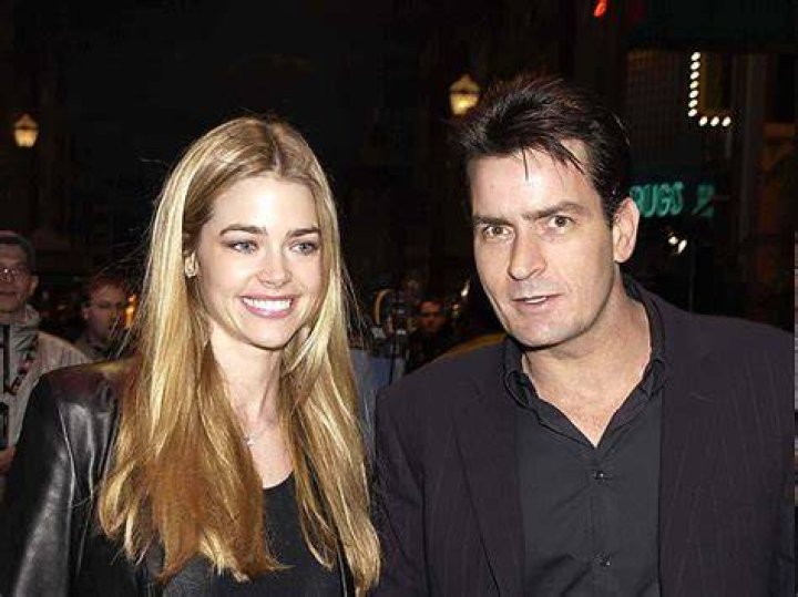 kyle and denise richards smiling holding wine glasses outside at party filming real housewives of beverly hills tv show