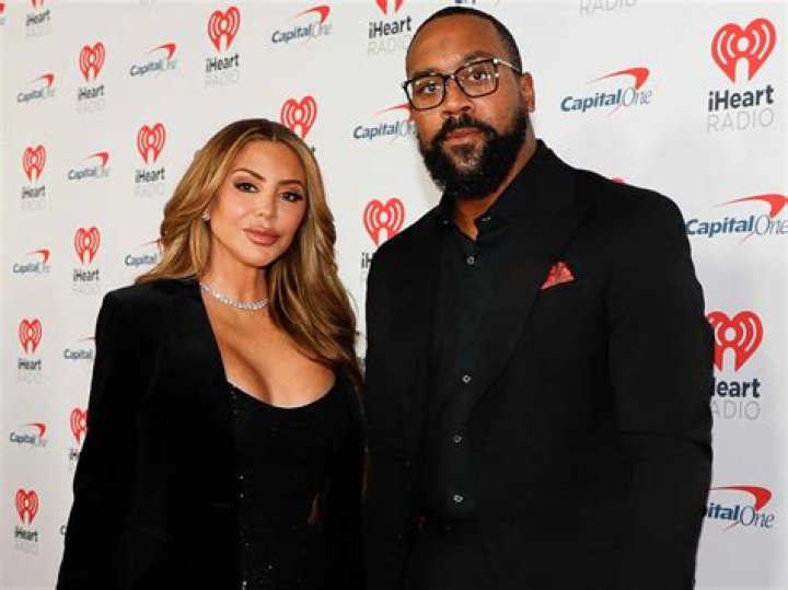 Larsa Pippen and Marcus Jordan posing for photo on a golf course