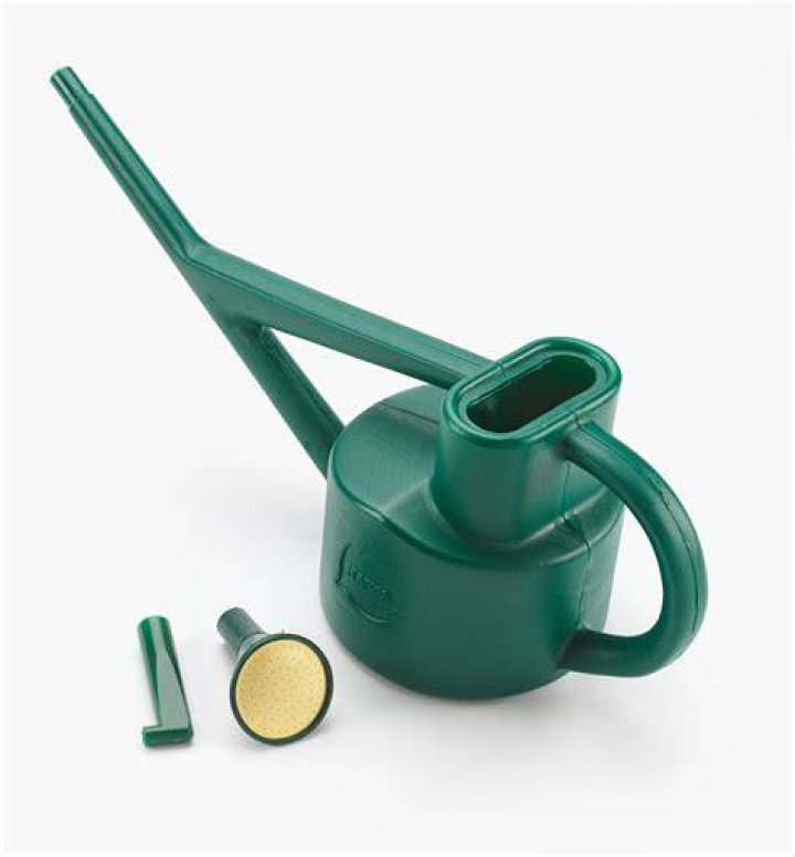 Minit watering can next to base Minit watering can next to base