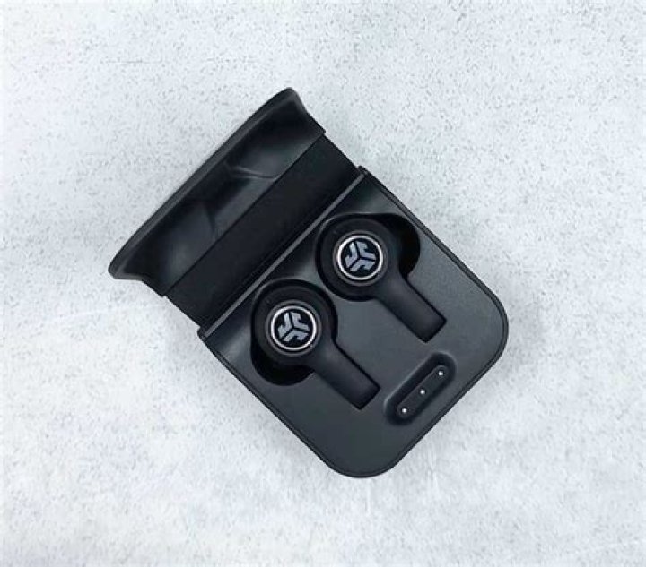 JLab_JBuds Air Executive-5_earbud touch control case One JLab JBuds Air Executive earbud outside of the case, which is standing vertically.
