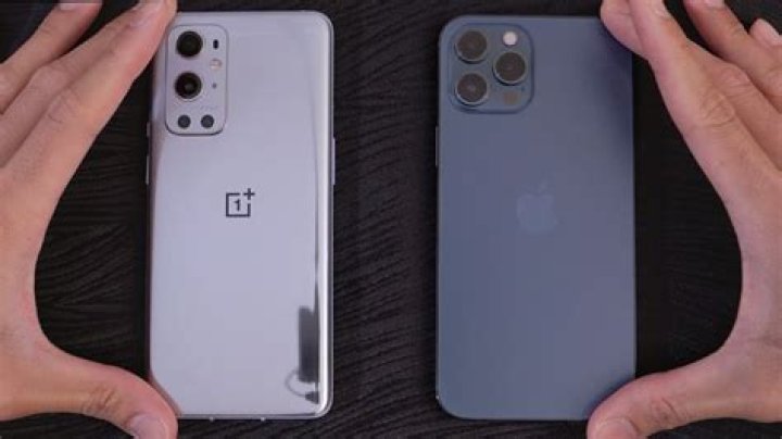 OnePlus 9 Pro vs iPhone 12 Pro Max OnePlus 9 Pro vs iPhone 12 Pro Max on couch arm