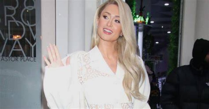 Paris Hilton smiling and waving
