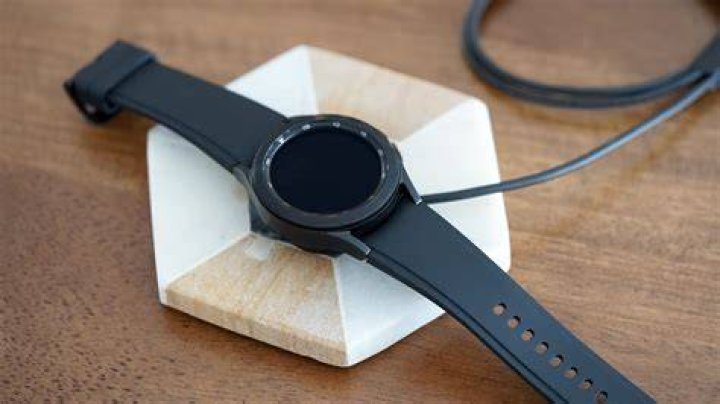 Galaxy Watch 4 Charging Samsung Galaxy Watch 4 rests on a beige cushion while charging.