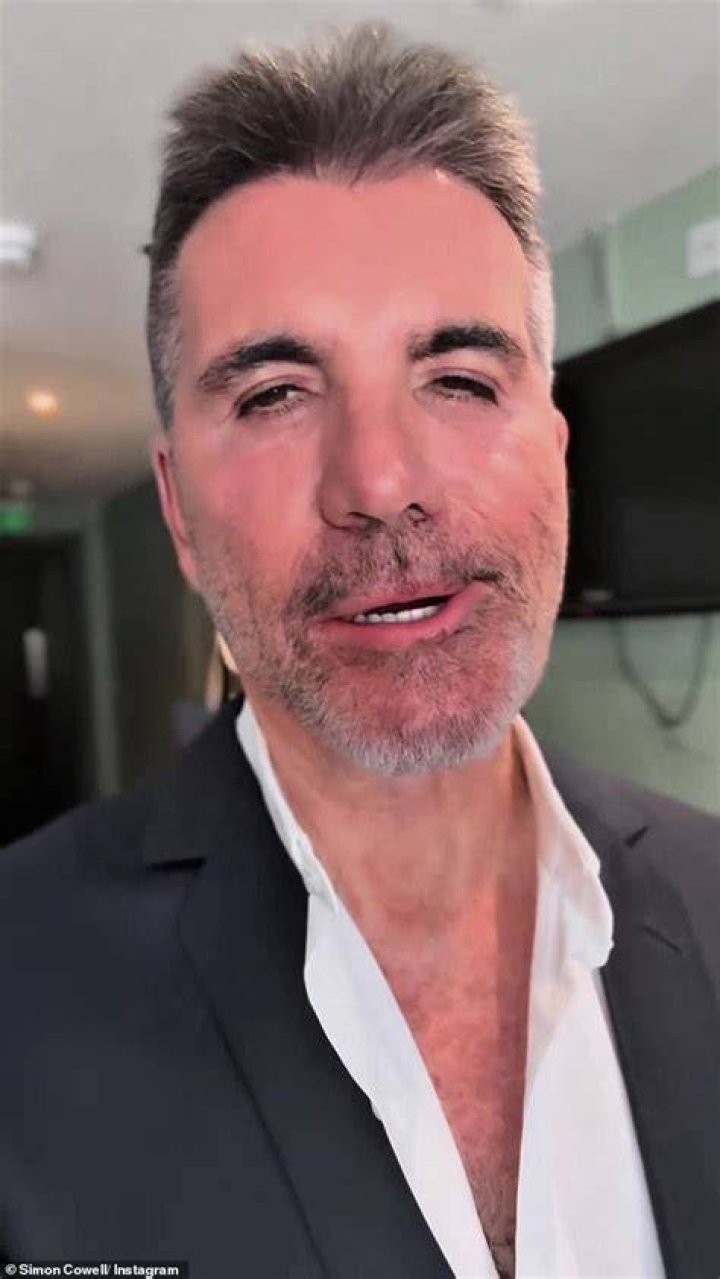Simon Cowell holding a finger to his mouth