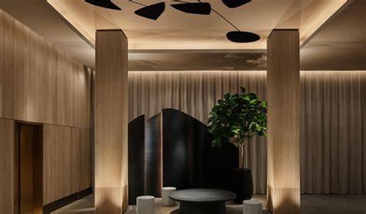The lobby at 11 Howard hotel, which features several small seating areas and a long dining room table