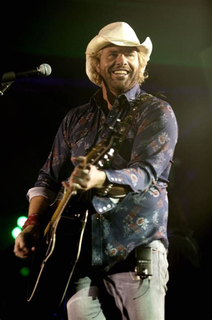 Toby Keith performing while playing guitar.